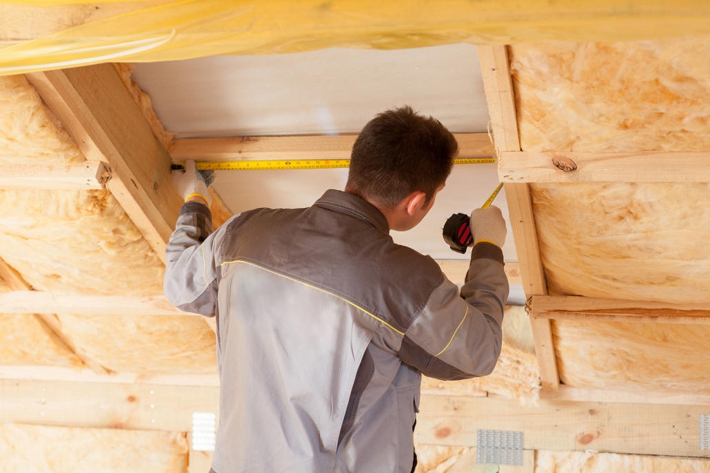 Back View Of Roofer Builder Worker With Ruler measuring