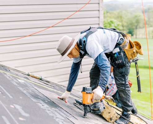 Roofer undertaking roof repair