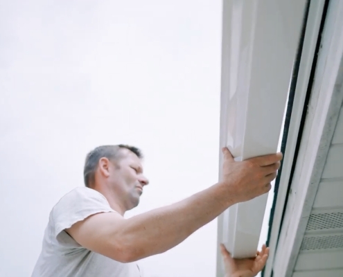 Valley Roofing & Exteriors employee adding seamless gutters